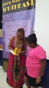 Author Beverly Smith signs a copy of her book, He Kept Me for a young admirer at her recent event, Black Wallstreet Southeast (June 2016)