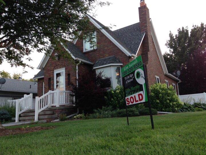 Brick house with sold sign on lawn