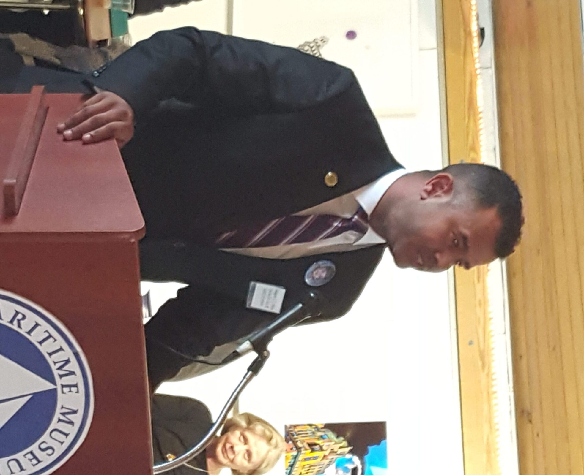 Speaker addressing audience at a podium